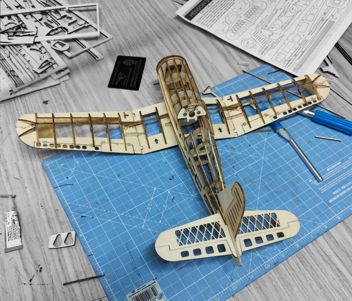 Balsa model airplane vought f4u corsair free flight kit under construction, hobby table